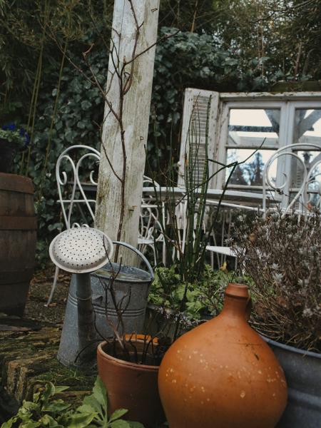 Rustic garden scene with watering can and pottery