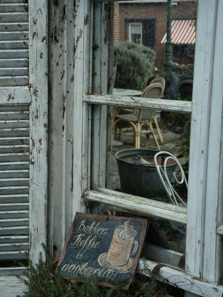 Chalkboard sign advertising coffee outside a cafe