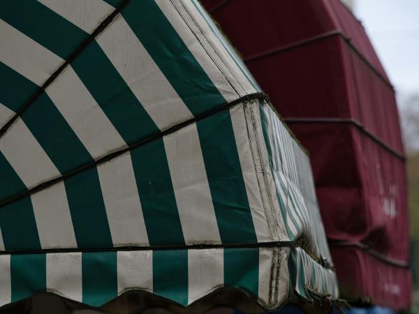 Green and white striped awning with red structure behind