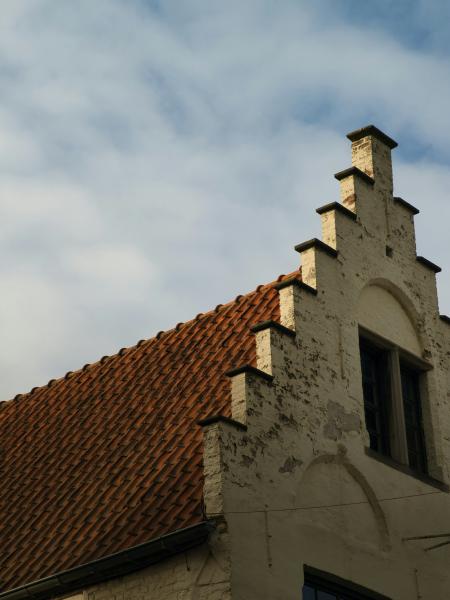 Historic building facade with stepped gable and tiled roof
