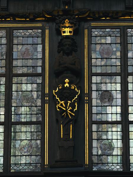 Ornate stained glass windows with a central dark column