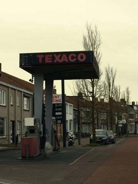 Texaco gas station with cars on street