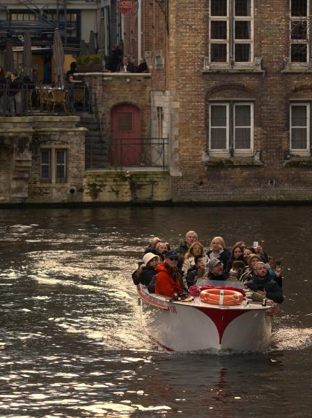 Tourists enjoying a boat ride on a canal