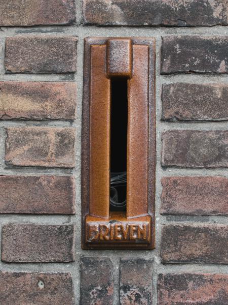 Vintage mail slot on a brick wall